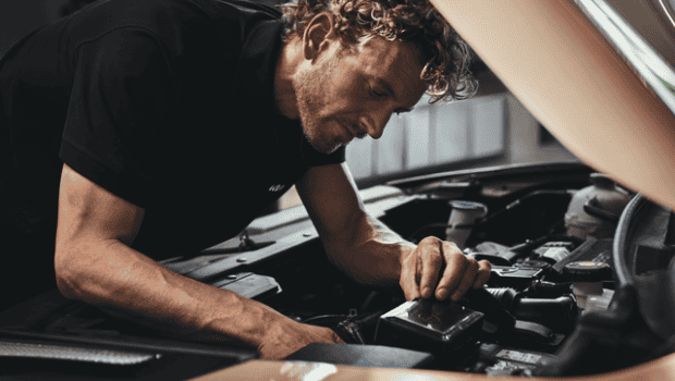 Kia Service Images - Technician working on battery.png
